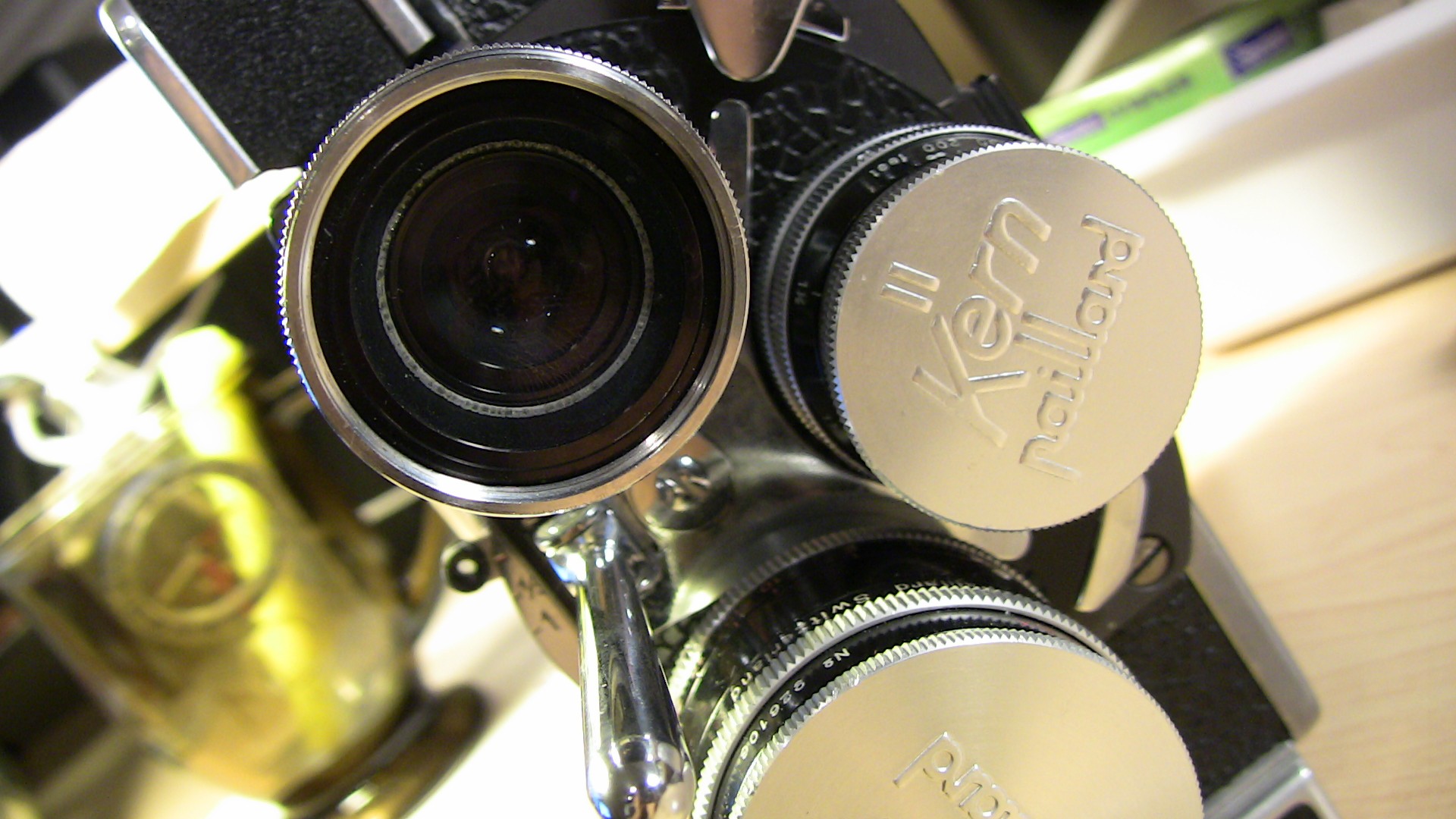 Image of this image features a close-up of a vintage kern paillard movie camera, showcasing its mechanical and lens details. the classic cinematic equipment is prominently displayed in a well-lit setting, enhancing the intricate design of the camera. ideal for enthusiasts of retro photography and