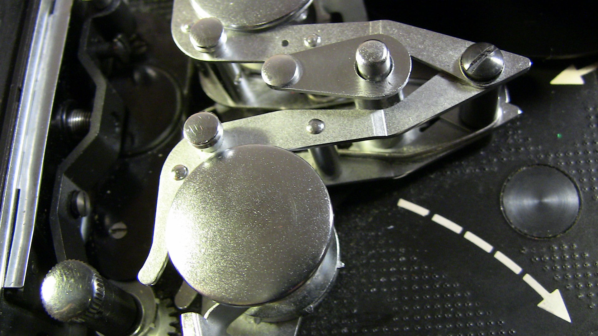 Image of close-up of a vintage movie projector mechanism, showcasing intricate metal components and gears. ideal for enthusiasts of classic cinema technology and film equipment.