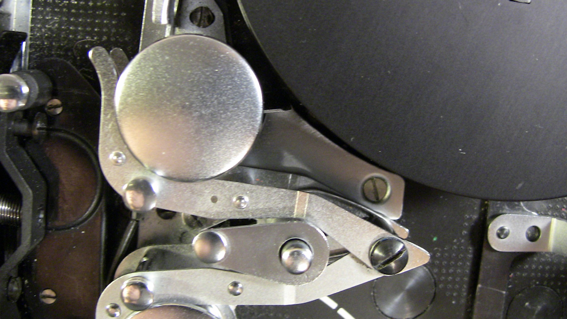 Image of close-up view of a mechanical device showcasing intricate metal components and levers. the image displays detailed engineering and industrial design, highlighting metallic textures and precision assembly. ideal for topics related to mechanics, engineering, and machinery parts.