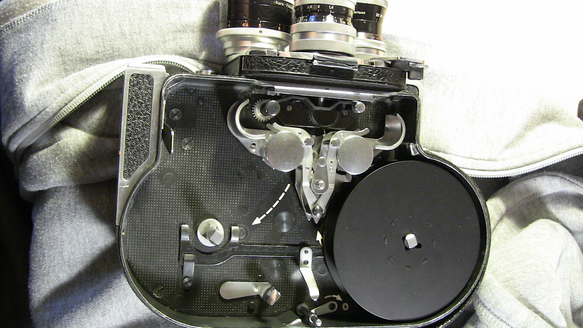 Image of this image showcases the internal mechanics of a vintage film camera, displaying intricate gears and components. the camera is likely a bolex, known for its classic design and precision engineering. this close-up view highlights the craftsmanship and complexity of analog photography equipment,