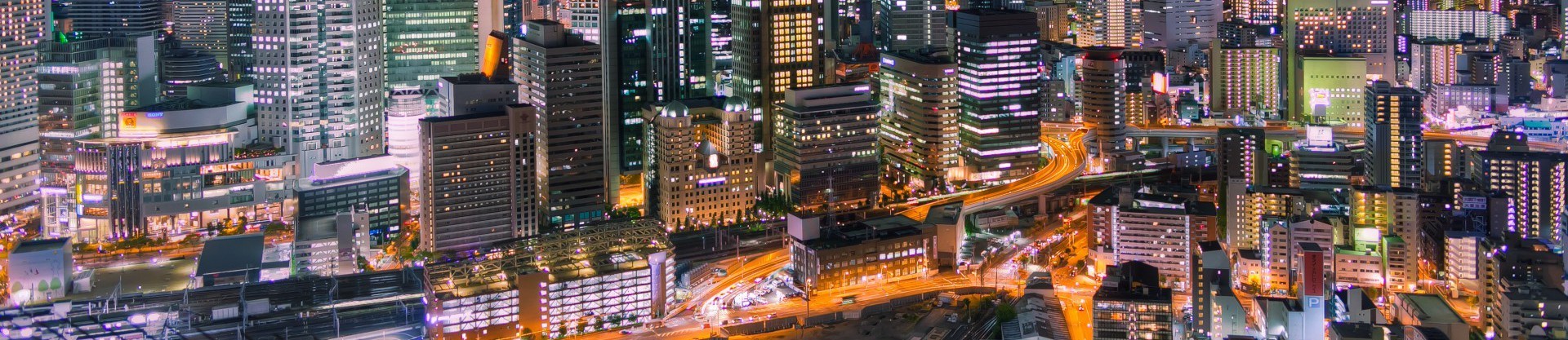 Image of vibrant cityscape of osaka at night, showcasing illuminated skyscrapers and bustling streets. the dynamic urban landscape highlights osaka's modern architecture, nightlife, and city lights. perfect for those interested in japan, urban photography, and night scenes.