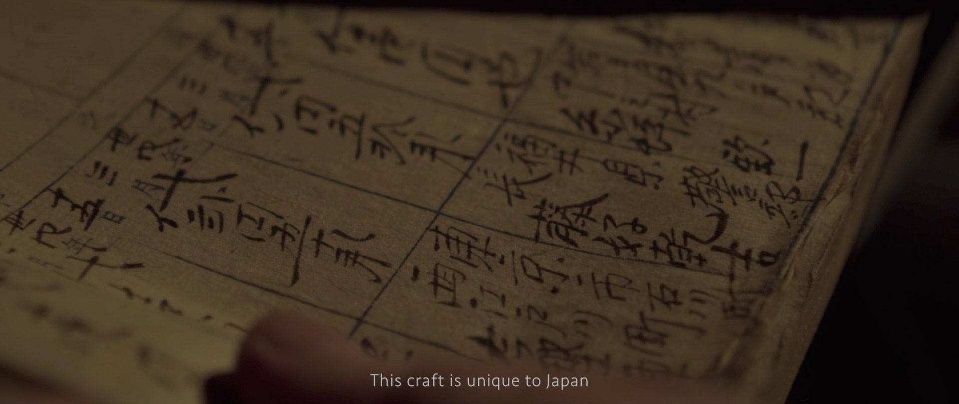 Image of ancient japanese craftsmanship document | close-up of a traditional japanese manuscript featuring detailed handwritten kanji characters. this historical document signifies japan's unique craftsmanship and rich cultural heritage, emphasizing the artistry of traditional japanese calligraphy.