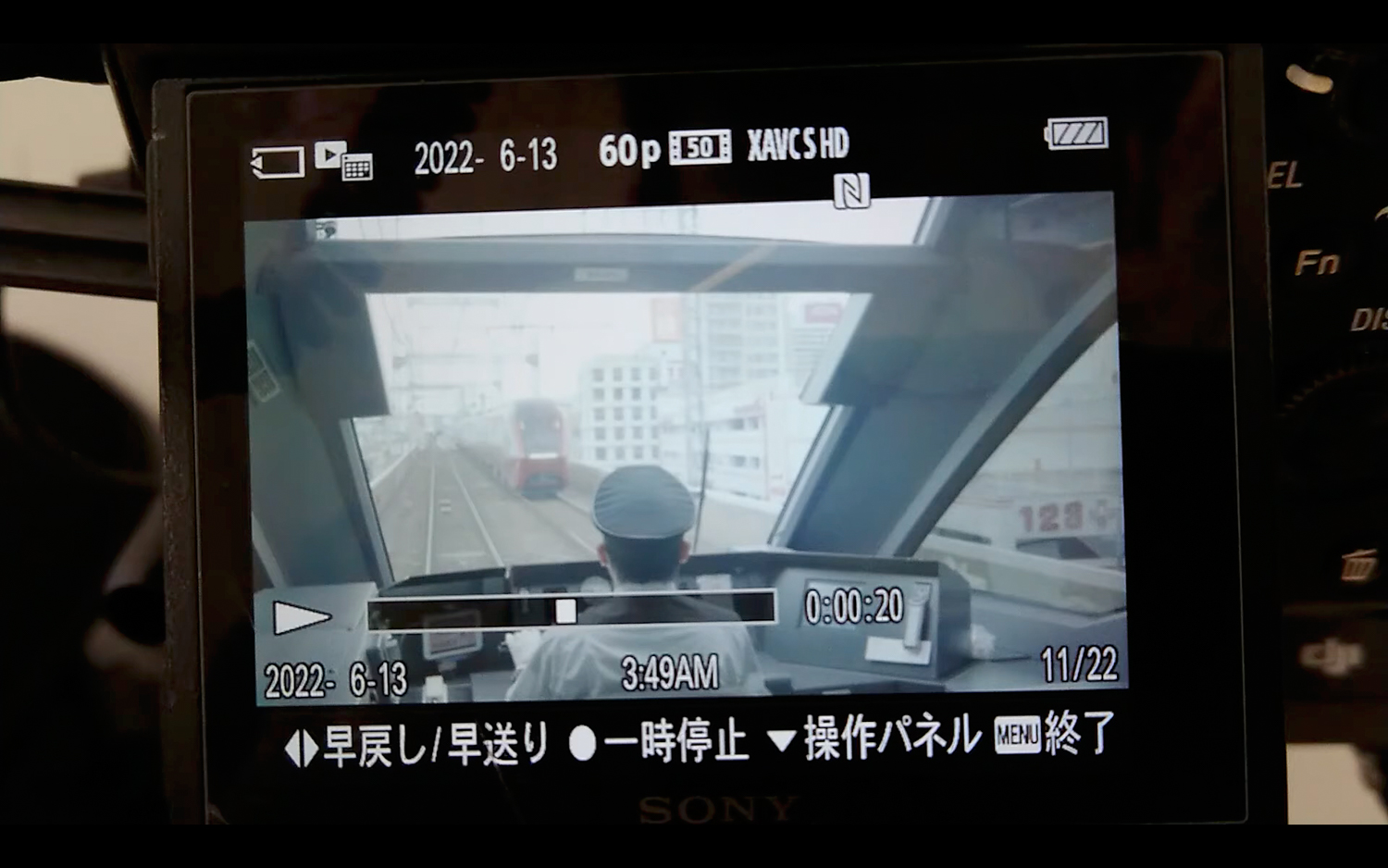Image of view from a train cockpit display, showcasing the perspective of a train operator on an urban rail track. the screen shows a timestamp of june 13, 2022, at 3:49 am, highlighting early morning travel. the interface includes various